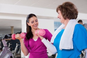 Mature Woman With Her Physical Trainer At the Gym