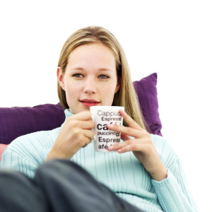 Young Woman Sitting and Holding a Cup of Coffee