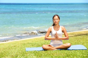 Yoga woman meditating woman relaxing by ocean sea doing the Sukh